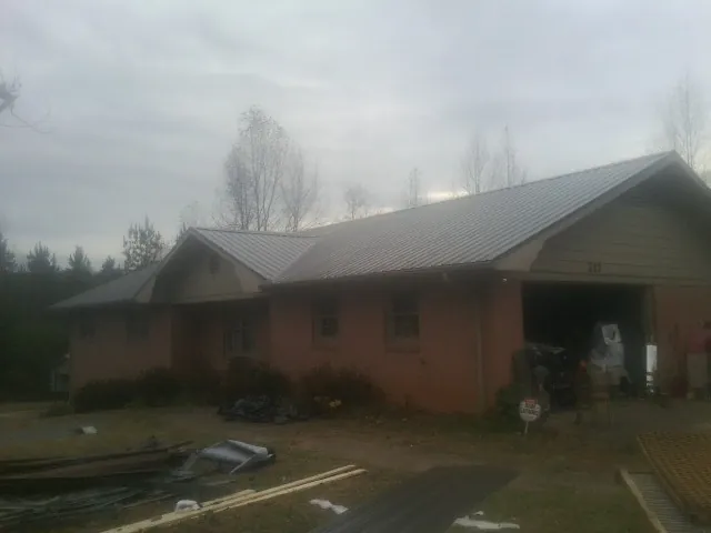 Gray metal roof on a stucco house with an attached garage in Warsaw